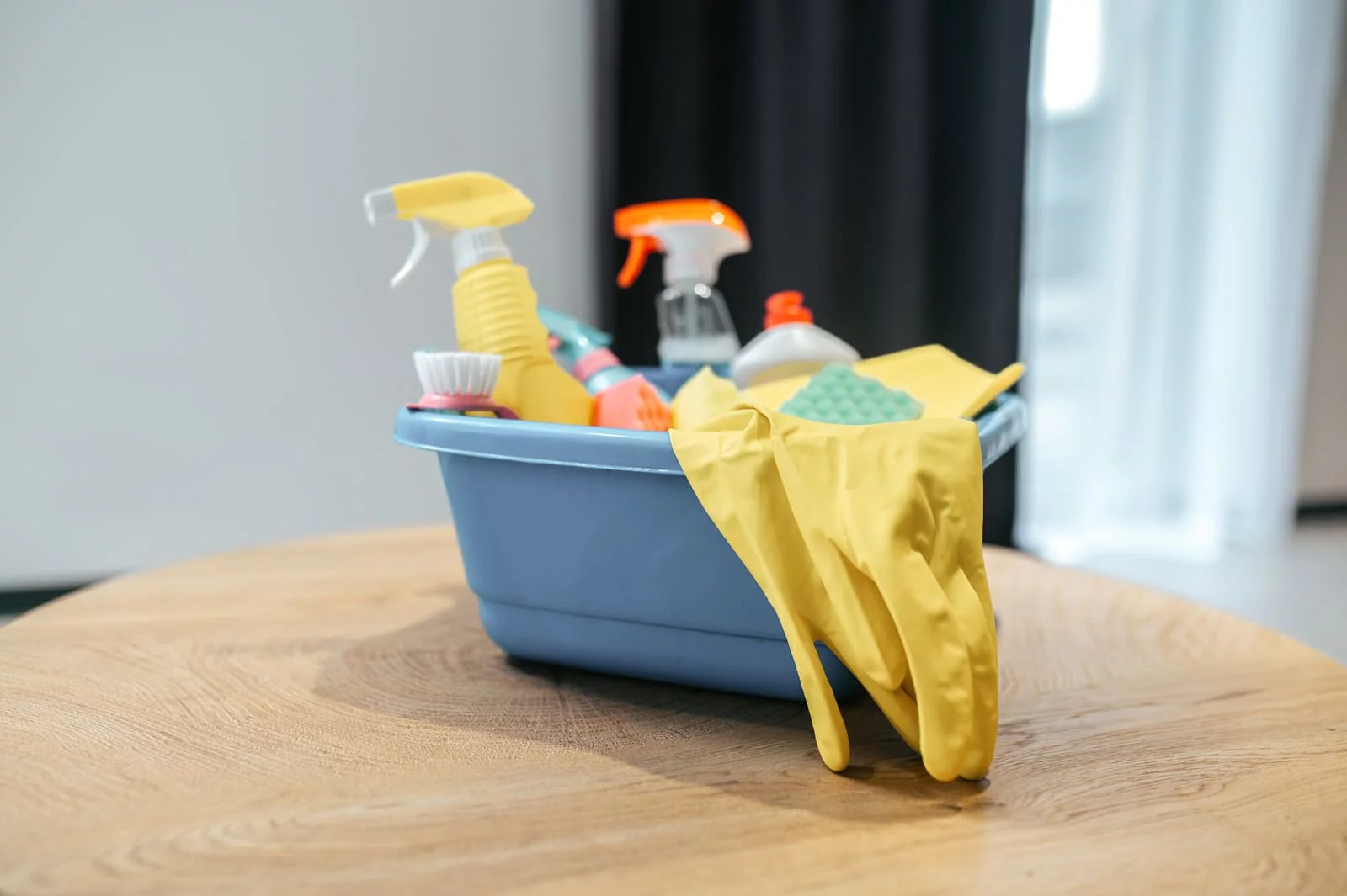Box with cleaning supplies on a table.